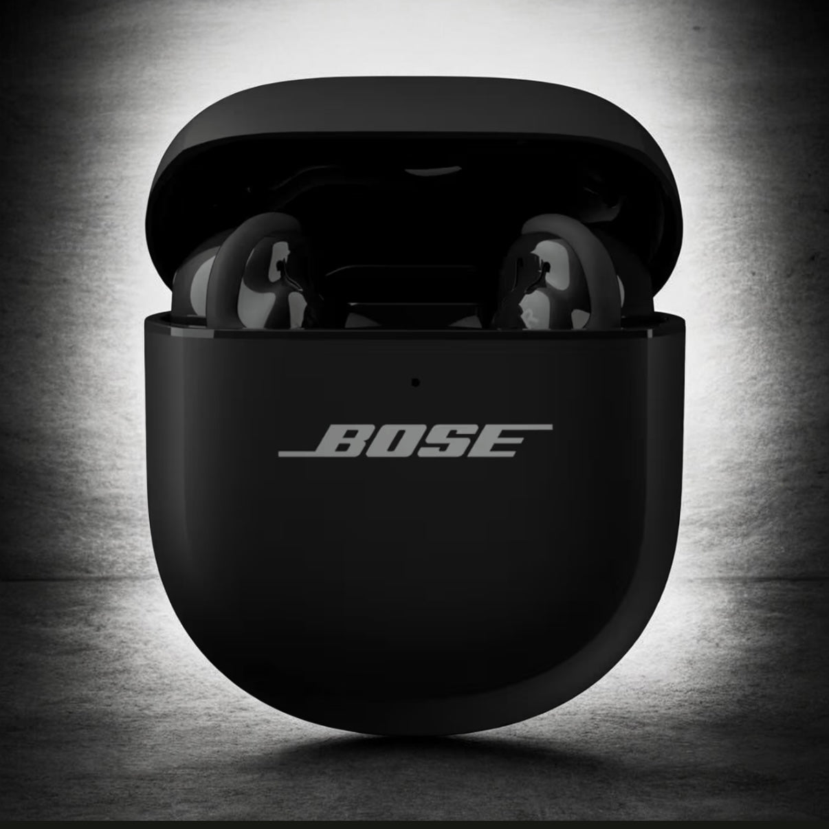 Bose wireless earbuds in black case on a dark background